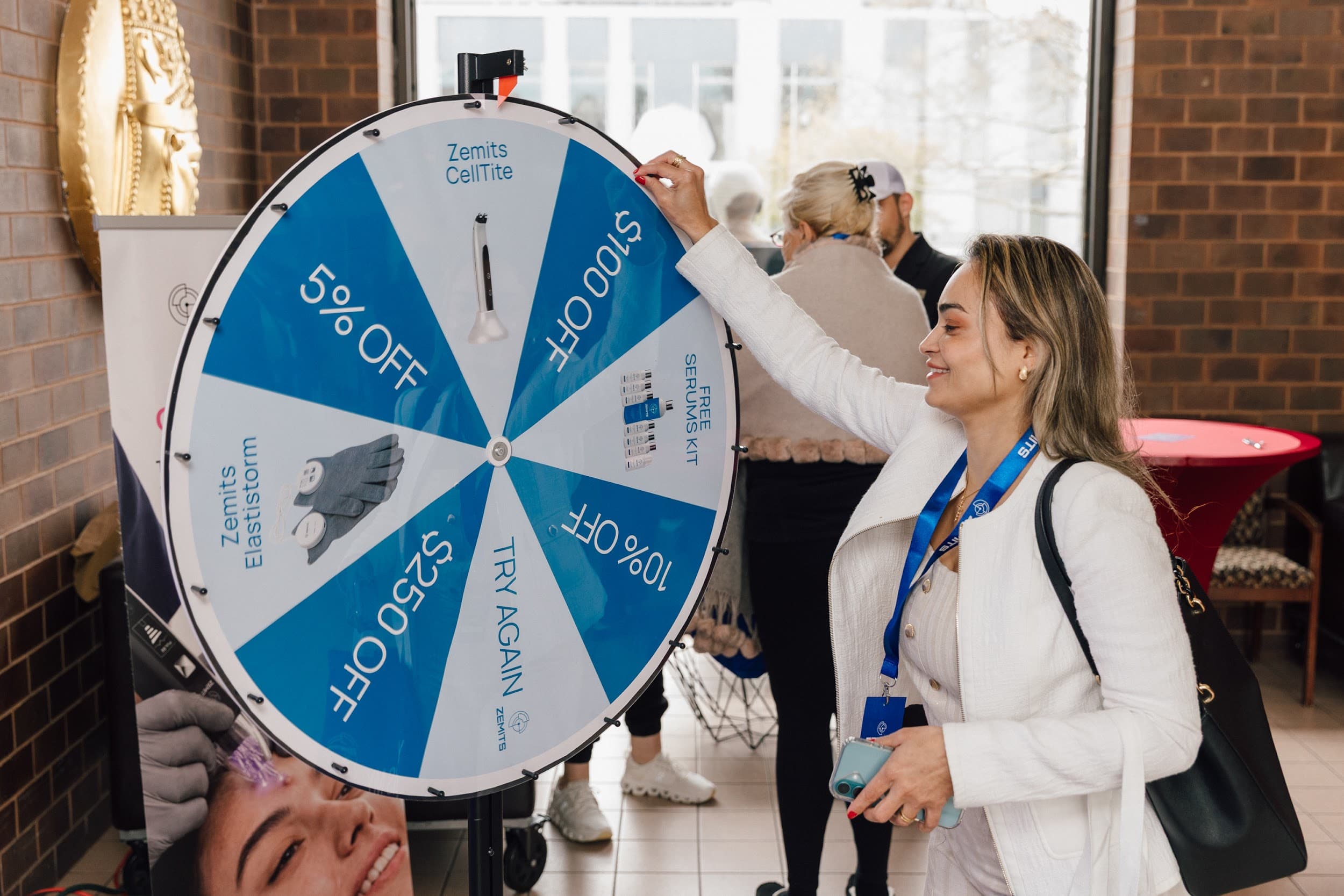 Prior Evolon forum attendee interacting with a prize wheel at a brand activation